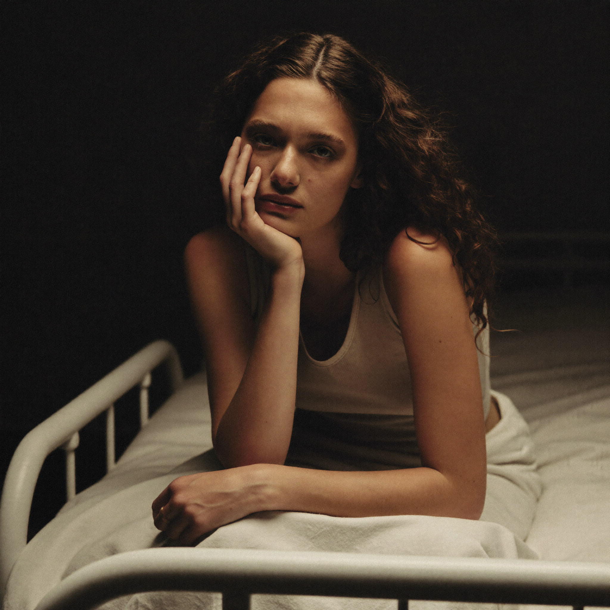 Woman resting in bed, the reality of a chronic fatigue crash